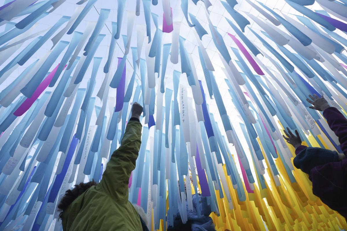 People reading the messages on Visions in Motion.